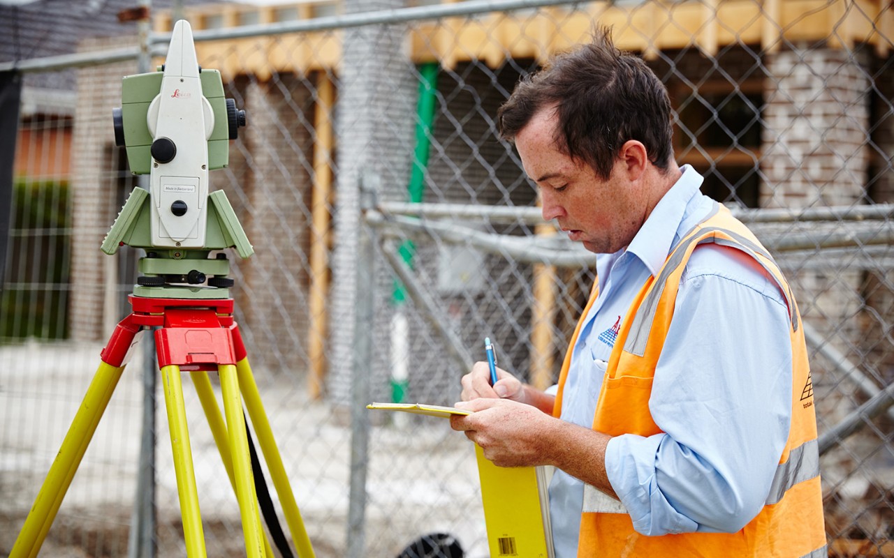 Surveyor writing notes on site